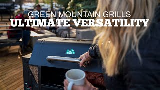 Woman operating a Green Mountain Grill with a coffee cup, showcasing the grill's ultimate versatility in a warm outdoor setting.