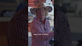 Person wearing a cowboy hat and checkered shirt discussing grilling techniques and equipment, emphasizing the importance of using a pellet grill.