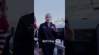 Woman in grilling attire speaking about pellet grills, emphasizing advice against purchasing certain models, with a grill in the background.