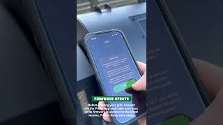 Person using smartphone to update firmware for GMG Prime 2.0 grill, illustrating WiFi Smart Control feature.