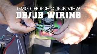 Hands connecting wires in a Green Mountain Grills pellet grill, demonstrating DB/JB wiring for the GMG Choice model.